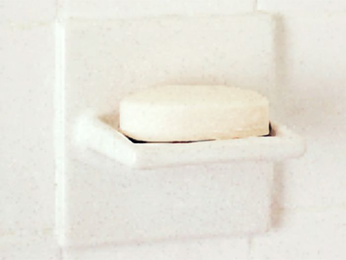 A soap dish with a bar of soap on it.