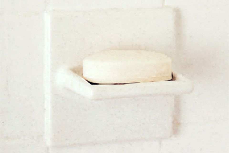 A soap dish with a bar of soap on it.
