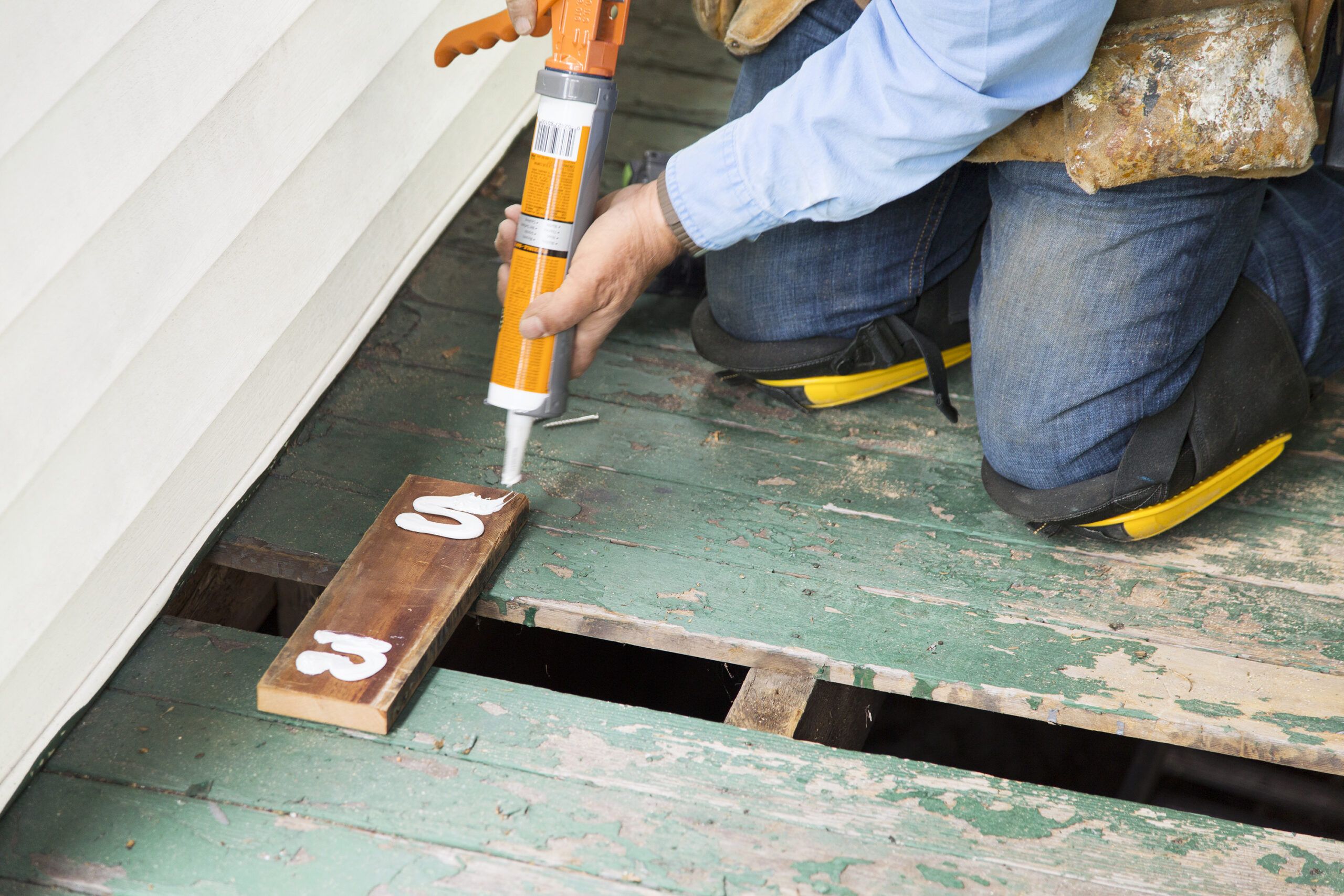 using an adhesive gun to add adhesive to a cleat