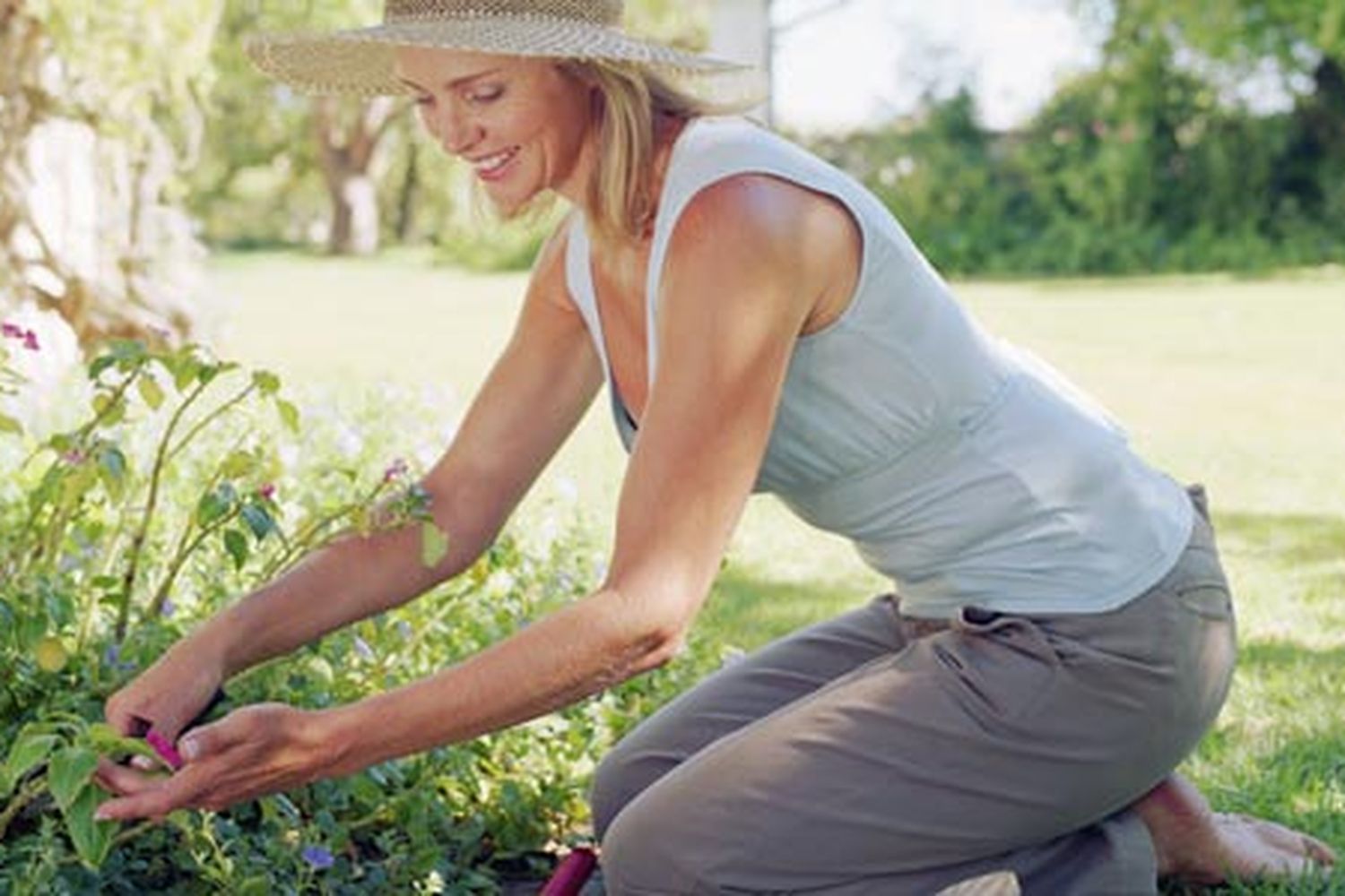 Image of a woman sitting in an ergonomic position to keep her gardening experience pain-free