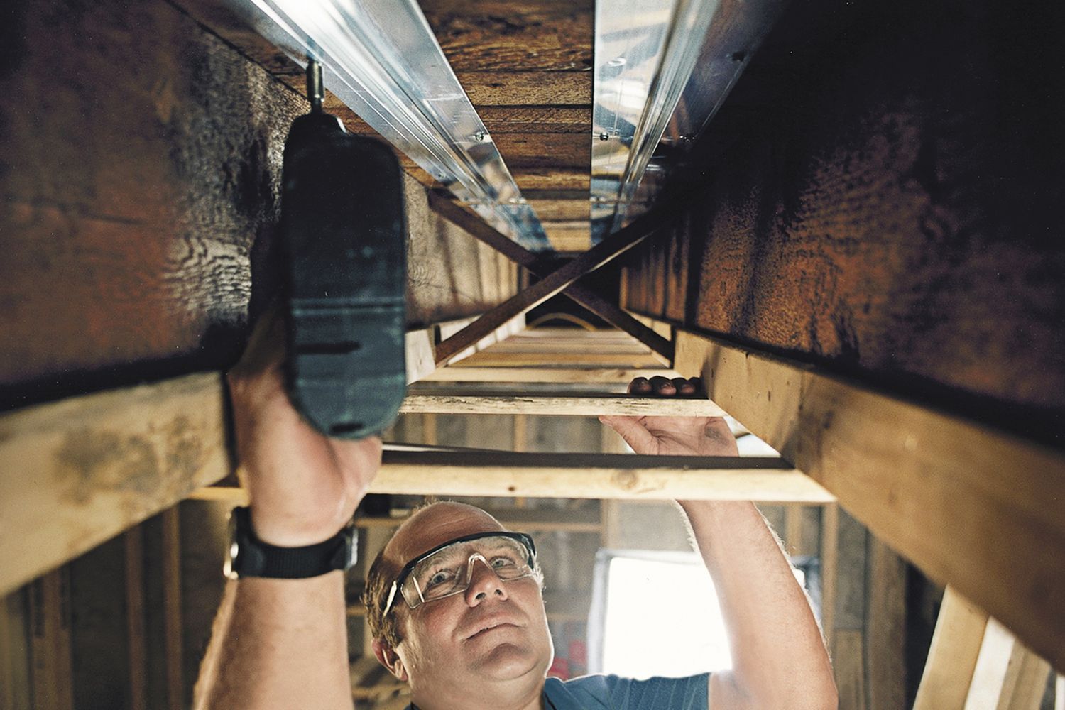 As a part of a home heating system, Richard Trethewey install radiant tubing in a house.