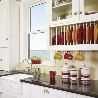 Kitchen cabinets with a plate rack underneath.