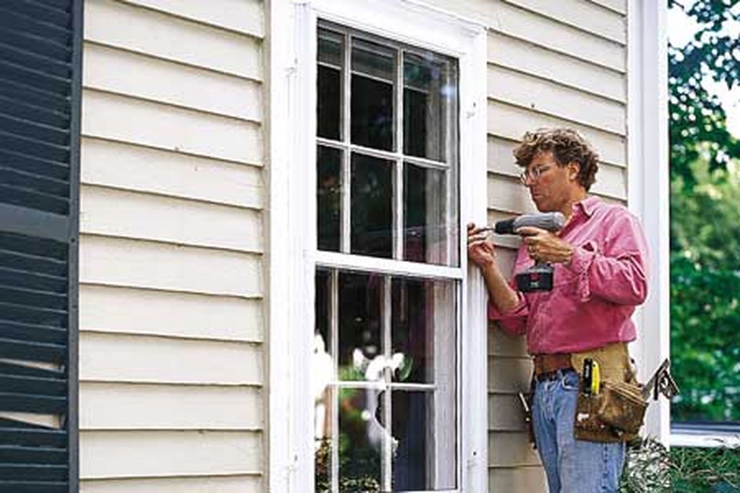 A man replaces window sashes.