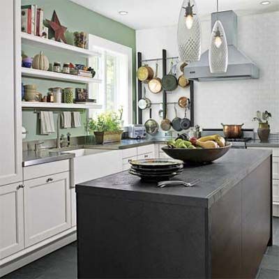 Sage green kitchen with shaker cabinets in a renovated 1880s house