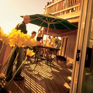 Decks that extend over a walkout basement or climb all the way up to a second story make natural places for outdoor entertaining. Safely secured to the side of a house with bolts, this double-tiered redwood deck in Albuquerque, New Mexico, is strong enough to accommodate a crowd.