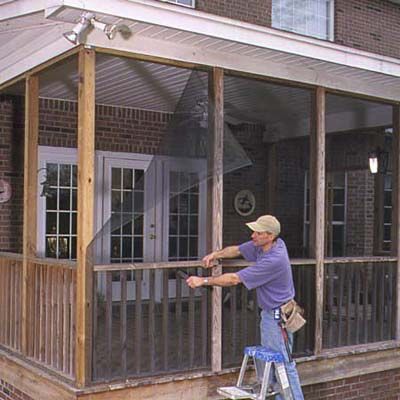 A man removes wooden battens.