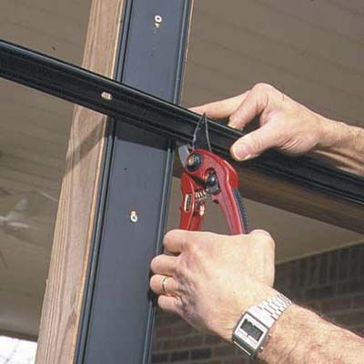 A man trims the base strips.