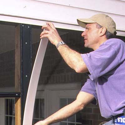 A man installs wide cap trim.