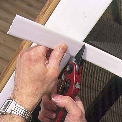 A man installs base strip trim.