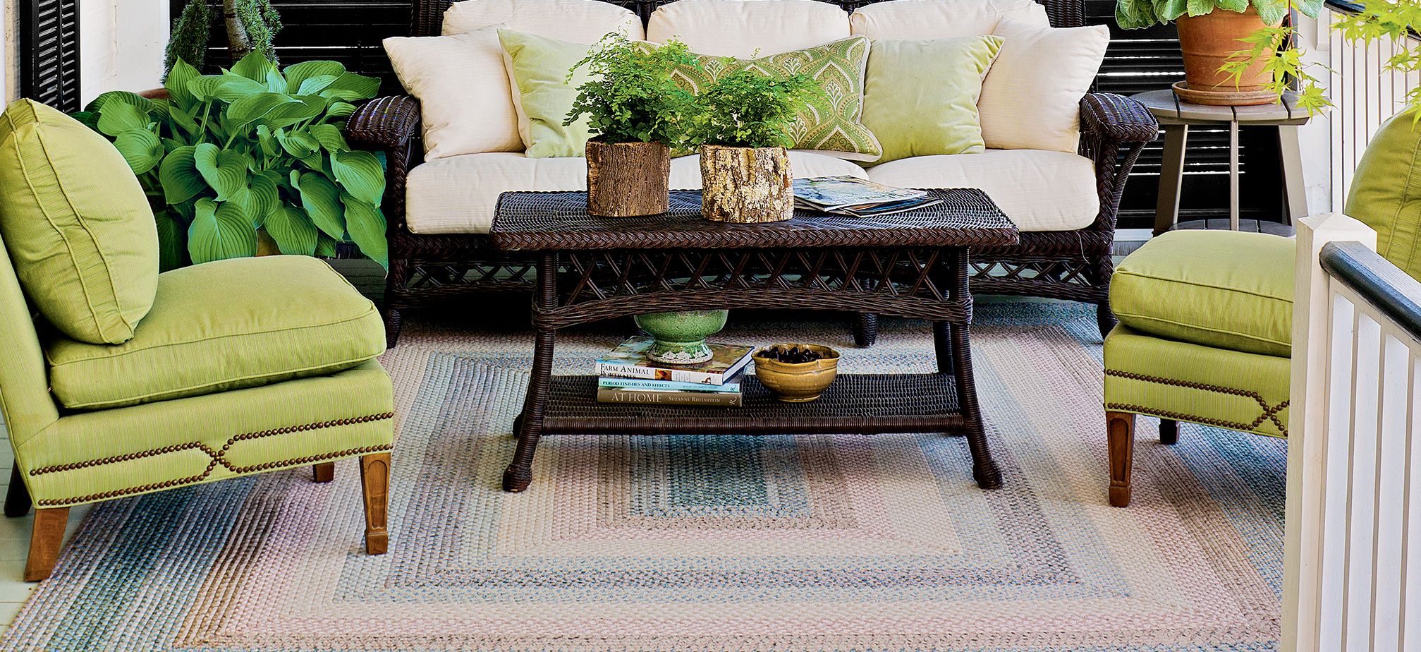 a rug, table, and furniture in an outdoor room