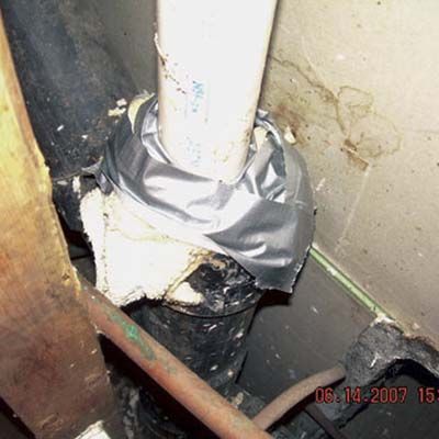 A barely secured pipe in danger of causing a gas leak.