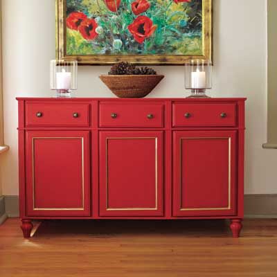 A red side table made from kitchen cabinets.