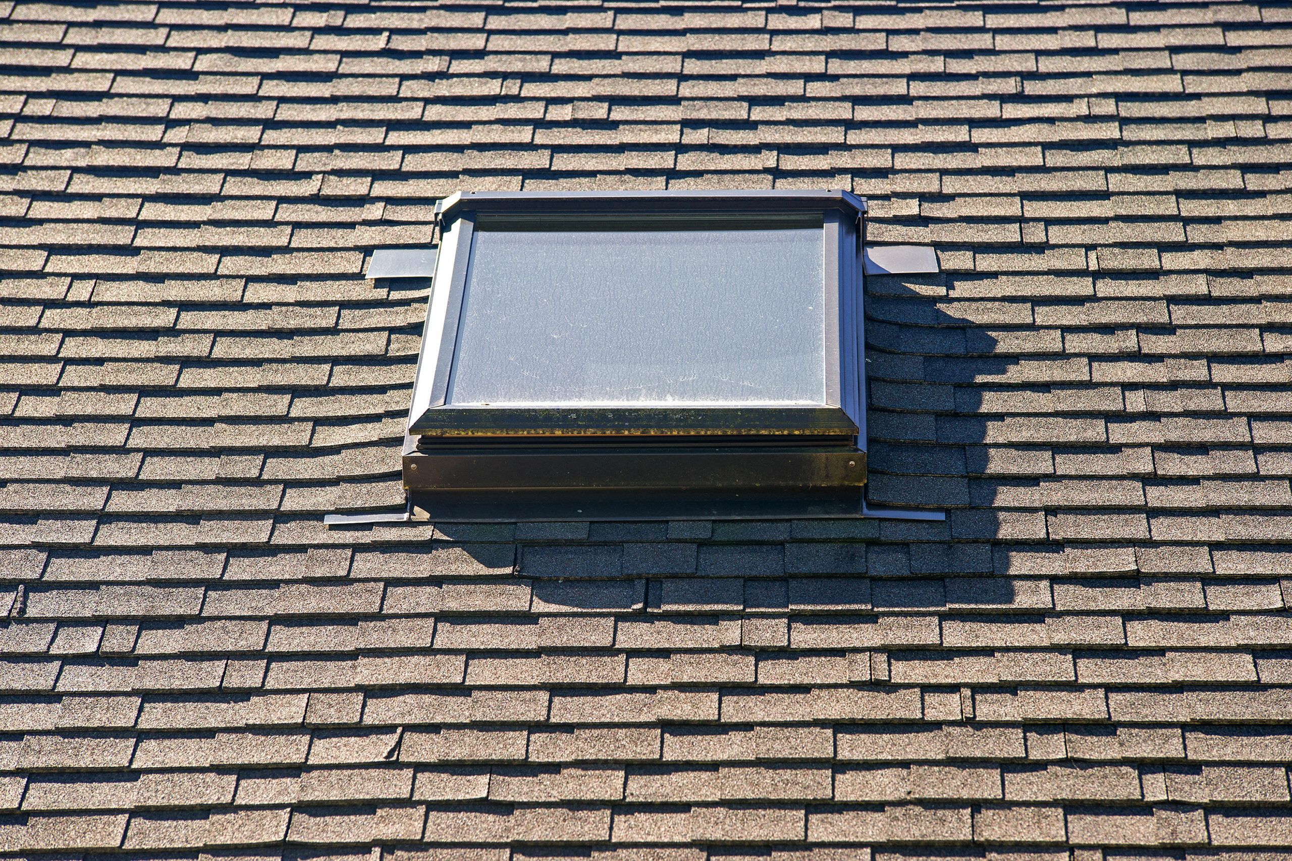 Photo of a skylight on a roof that was replaced during the process of roof replacement