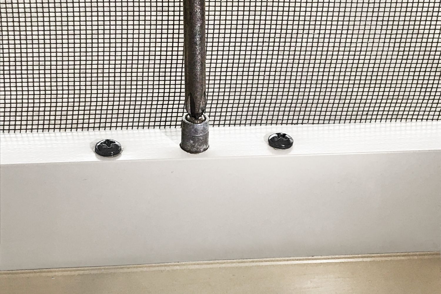 an up close view of a repair of a sliding screen door