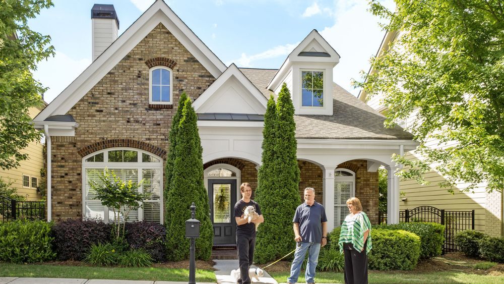 a home with a family out front waiting on a home appraisal