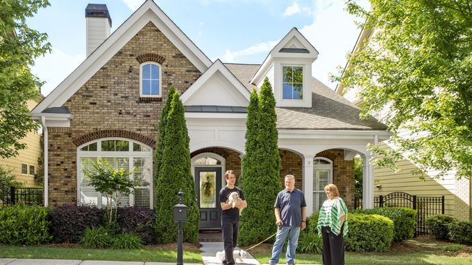 a home with a family out front waiting on a home appraisal