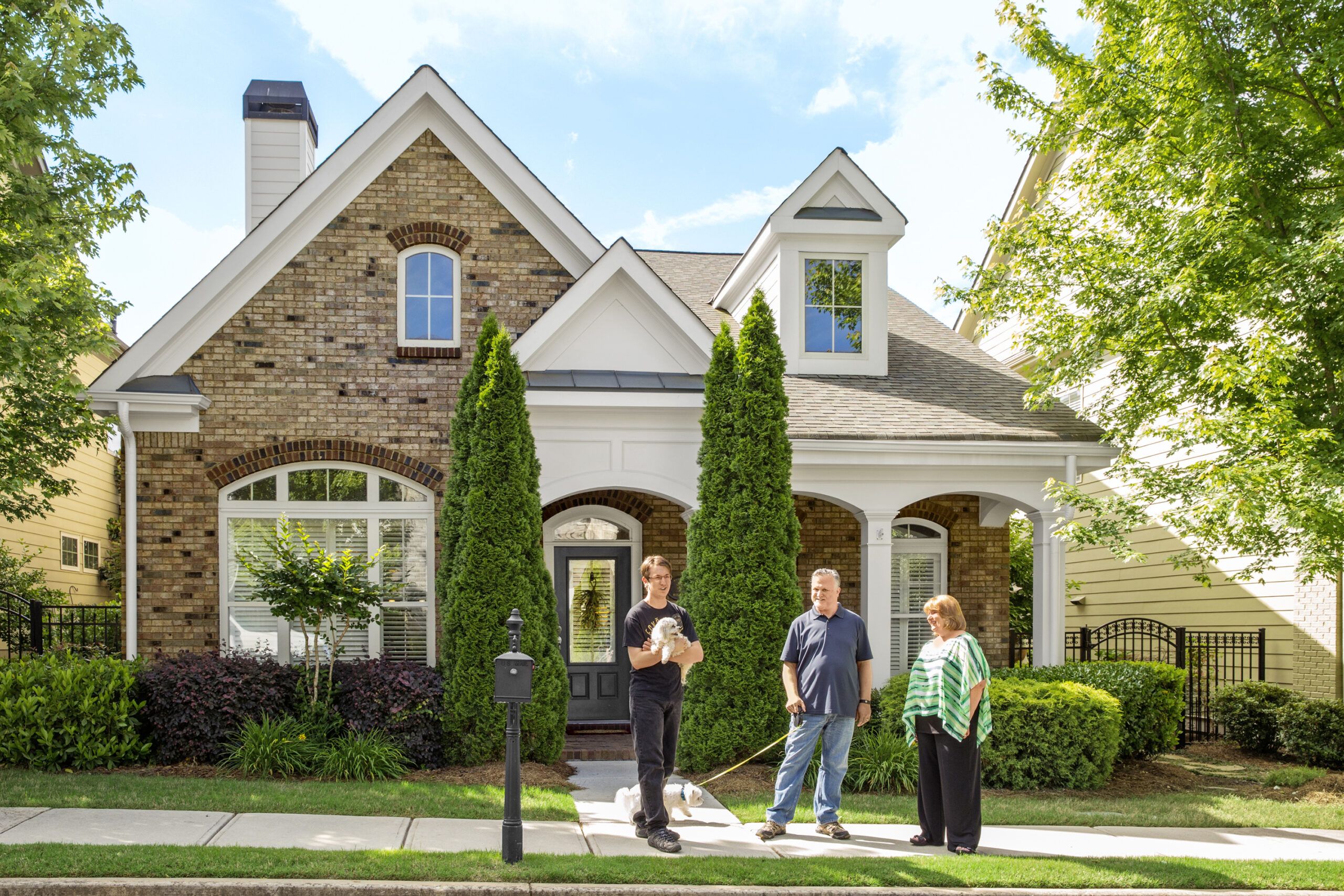 a home with a family out front waiting on a home appraisal