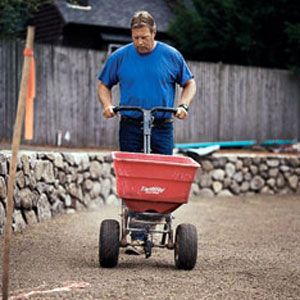 A person preparing the soil for sod