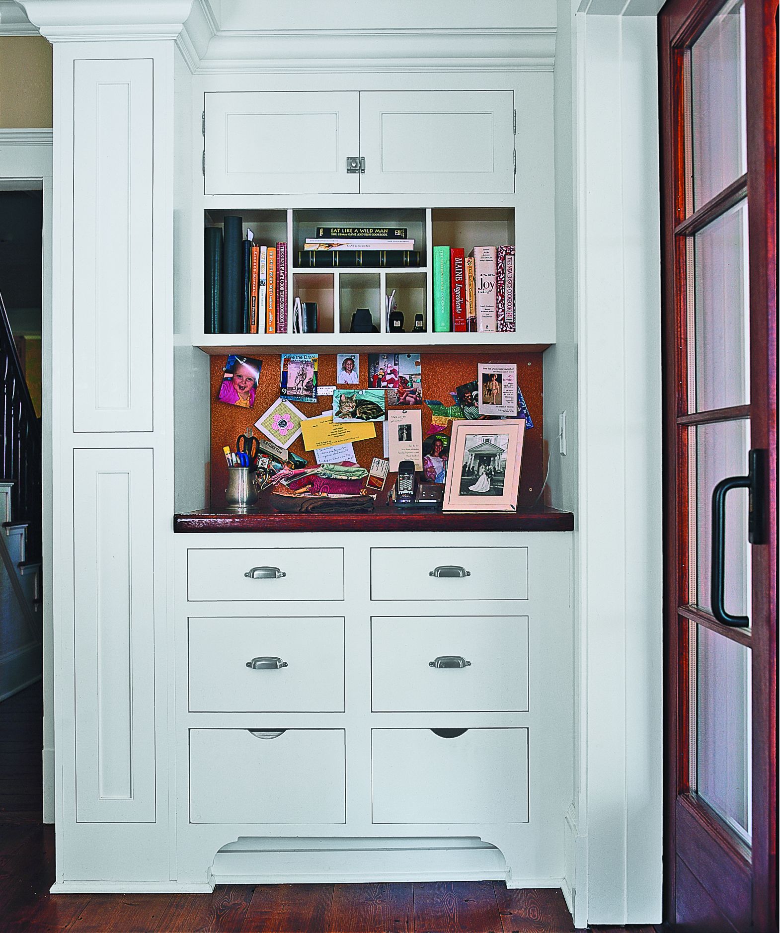 A stand up desk with built in drawers and cabinets for storage.