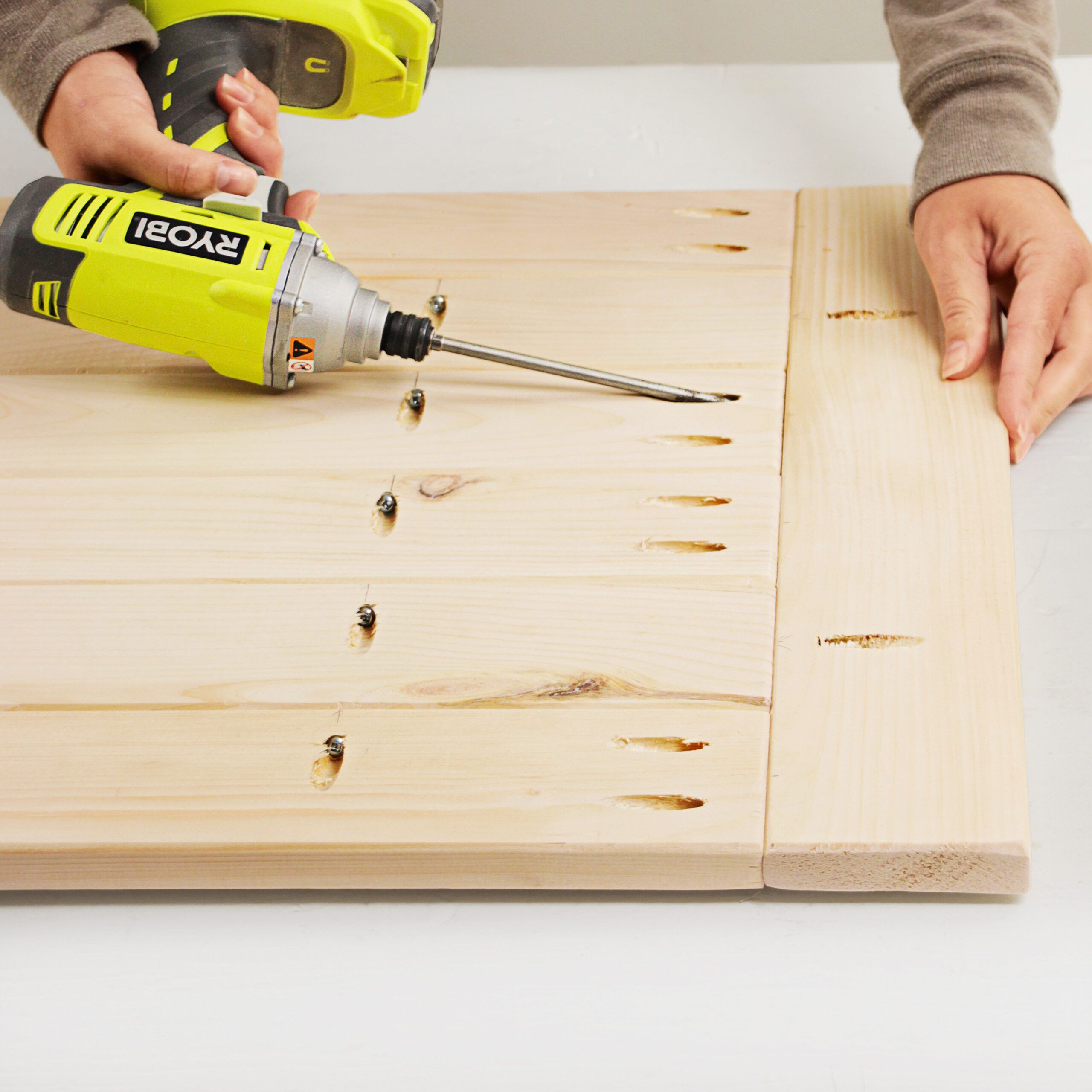 drilling angled holes into the tabletop of the coffee table 