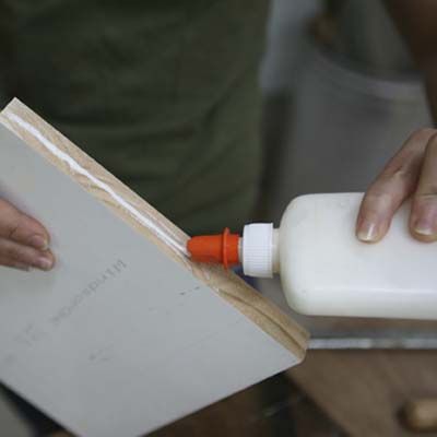 Image of a person securing the shelves of a DIY stylish bar cart in place. 