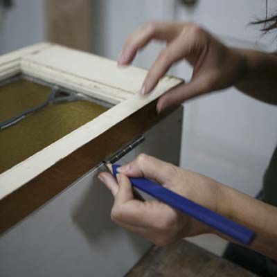 Image of a person installing hinges on their DIY stylish bar cart