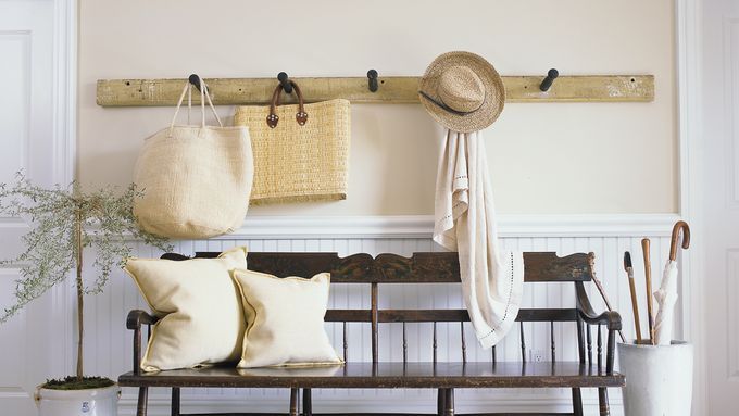 a bench, coat hooks, and umbrella stand