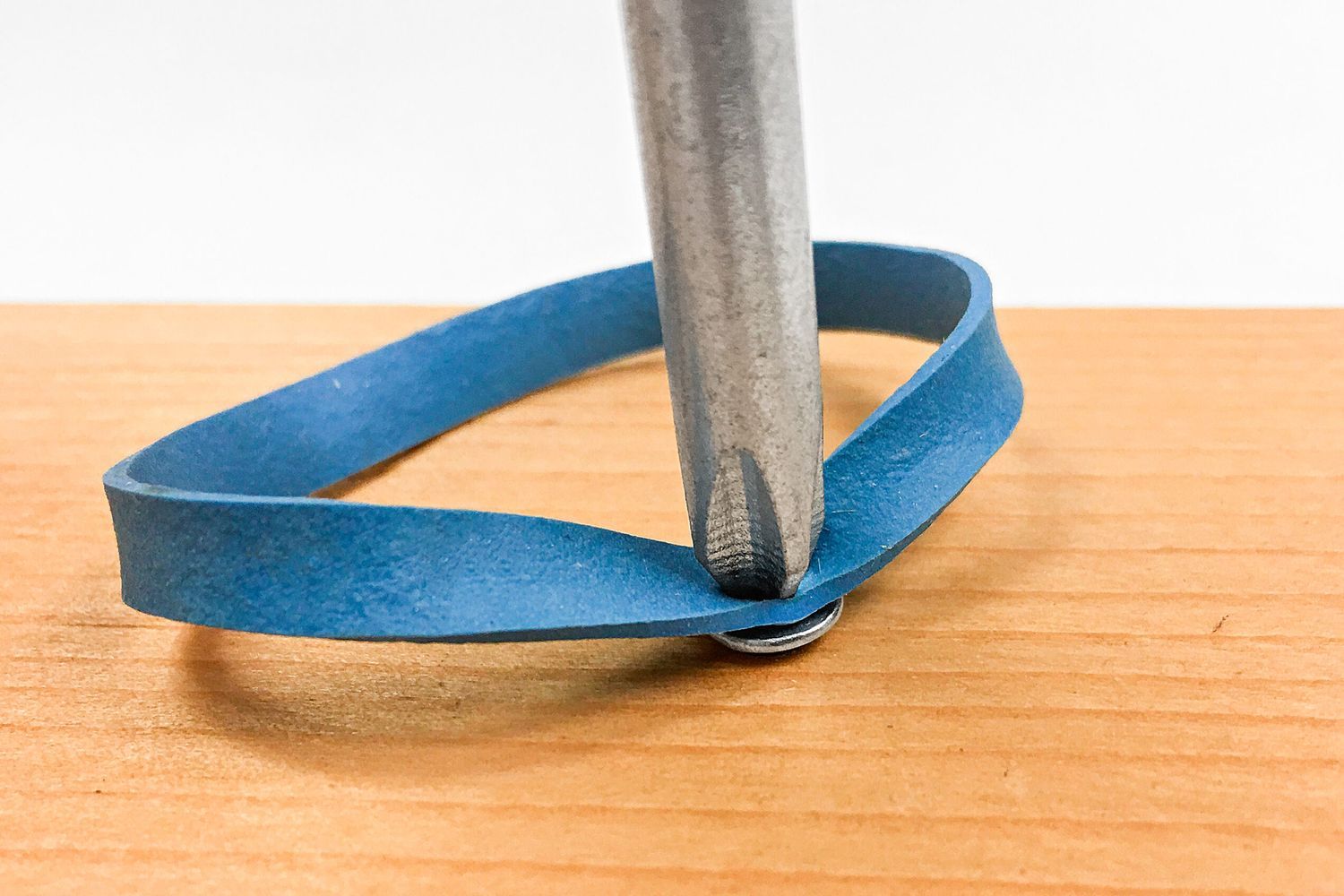 using a rubber band to remove a stripped screw