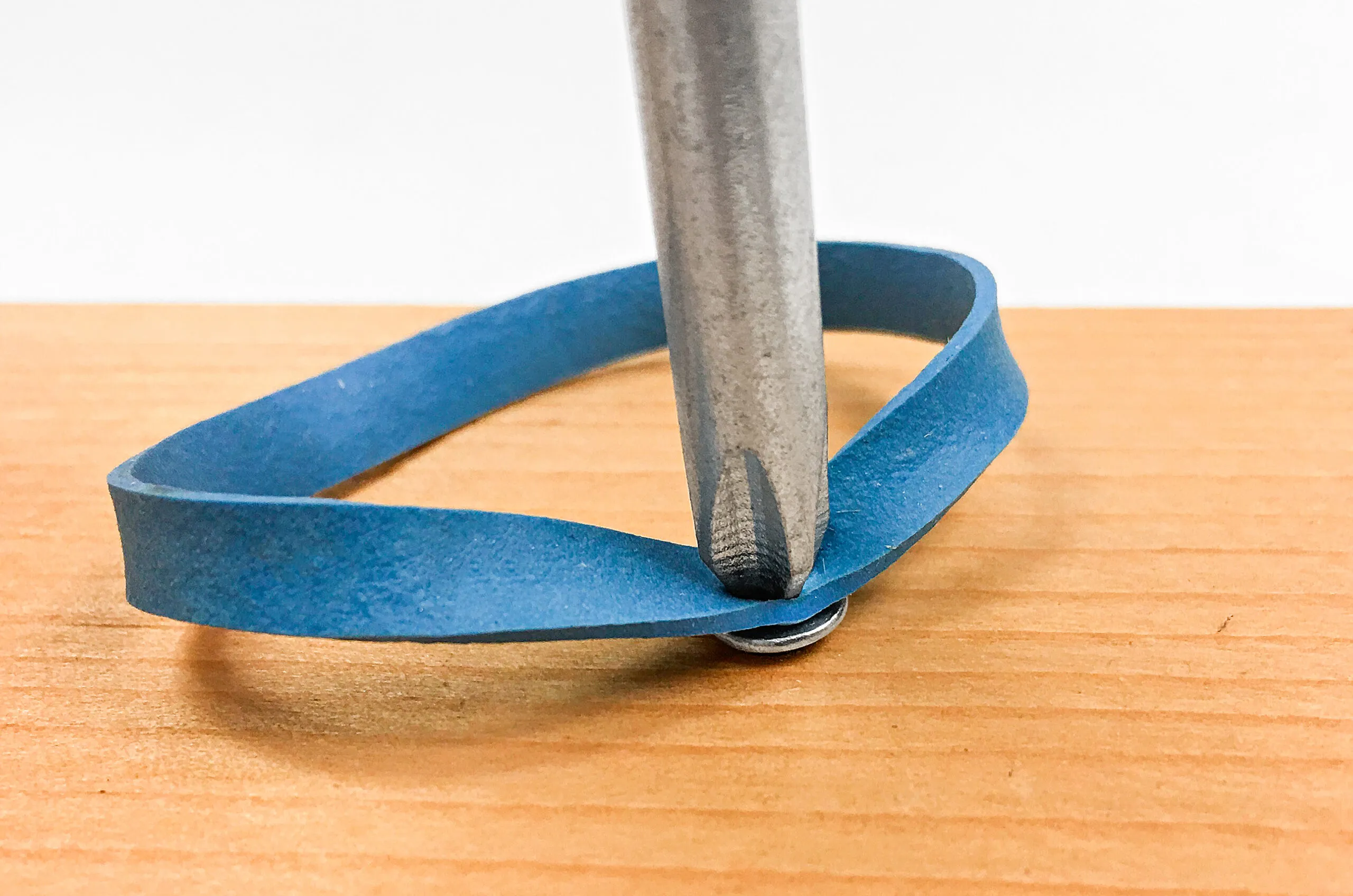 using a rubber band to remove a stripped screw