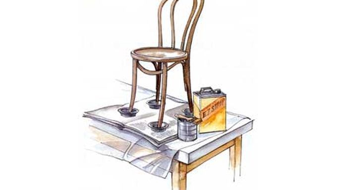 An illustration of chemical stripper sitting on a floor by a chair.