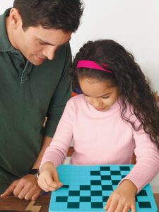 Man and child adding non-skid tape to the step stool.