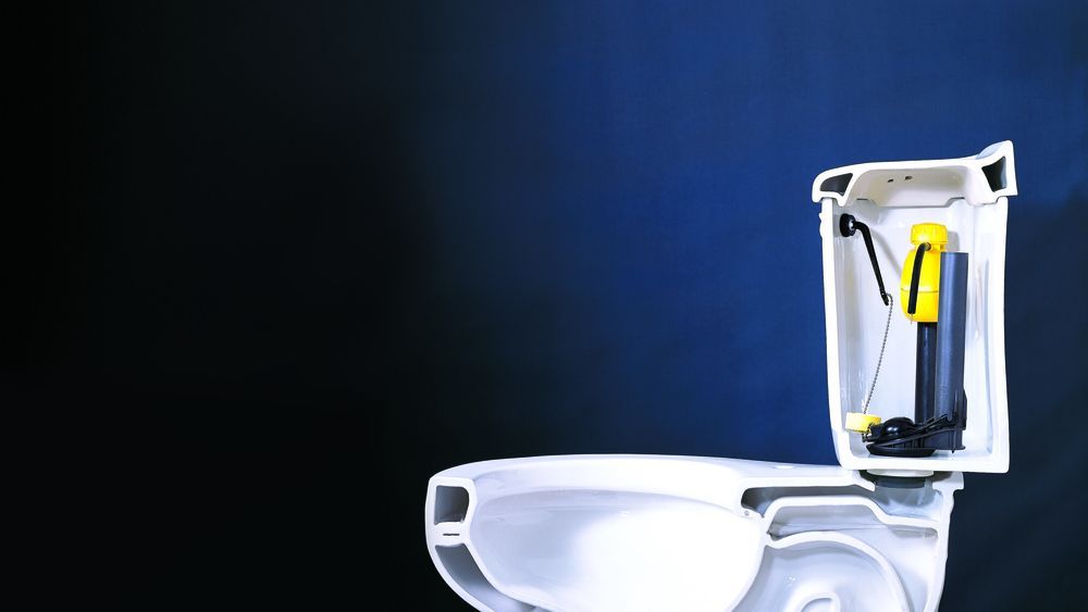 A low flow toilet against a dark blue background.