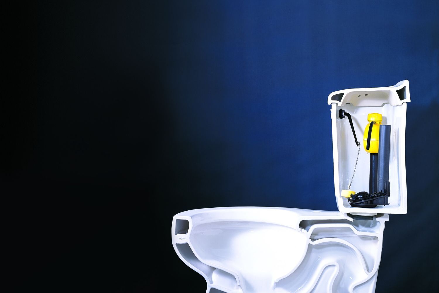A low flow toilet against a dark blue background.