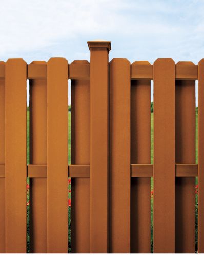 A composite wood fence in a yard.