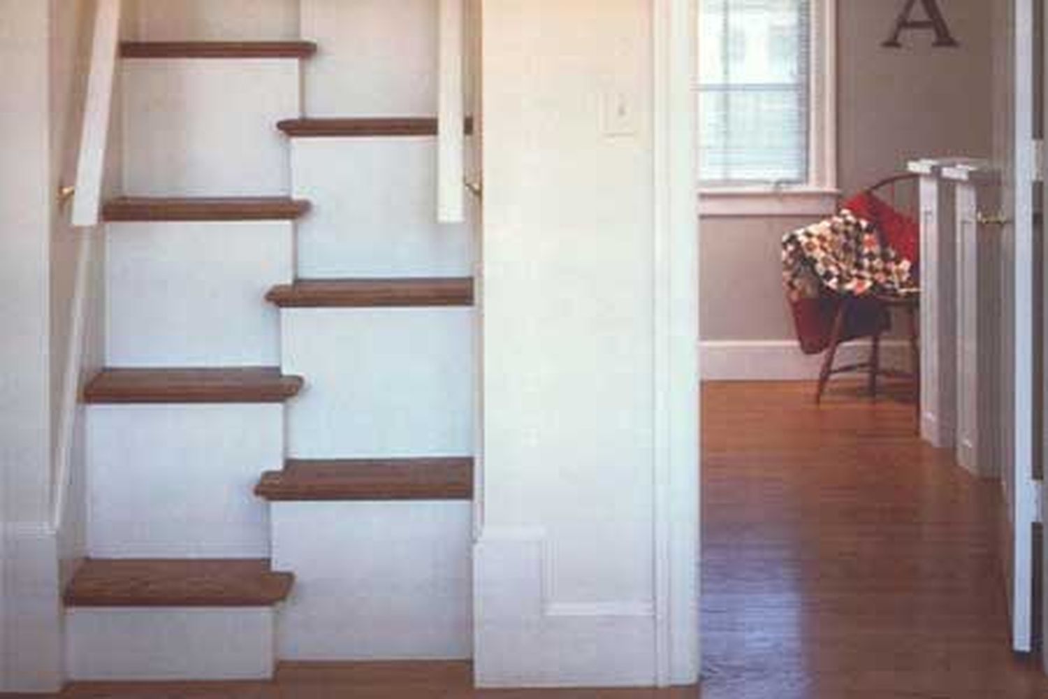 Alternate-tread stairs in a home leading up.