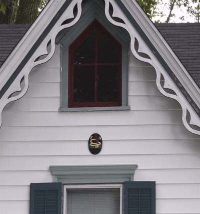 House with gingerbread trim along the roofline. 