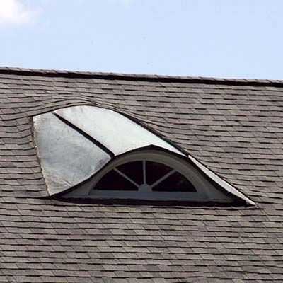 Eyebrow dormer on top of a Victorian home