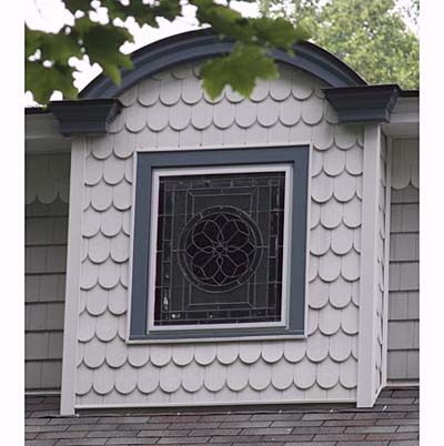 Victorian home with patterned and colored glass window. 