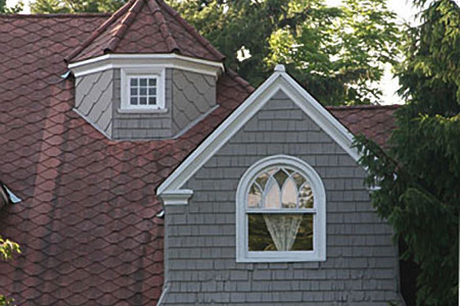 Victorian-style windows on a Victorian-era home.