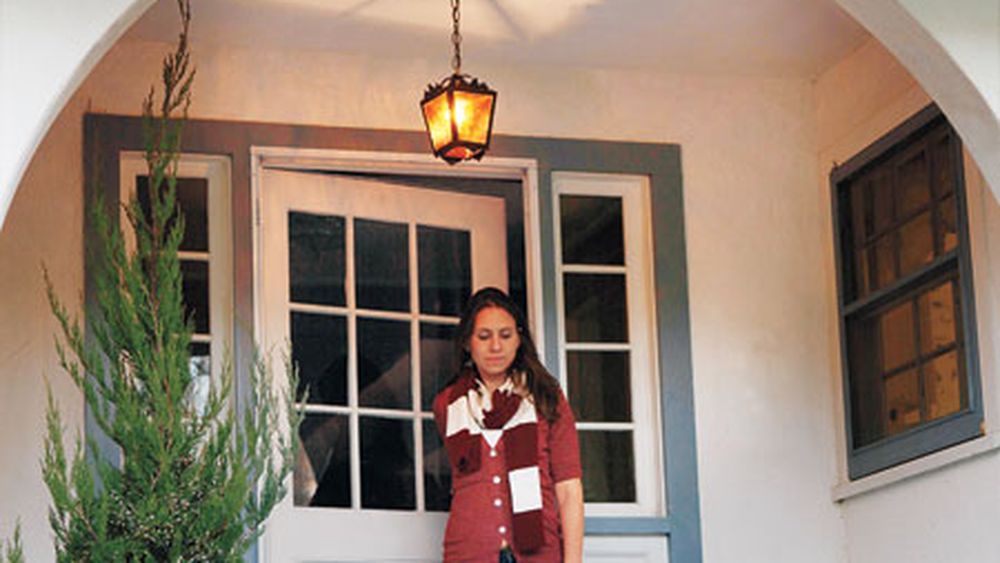 a vintage entry lantern hanging on a porch