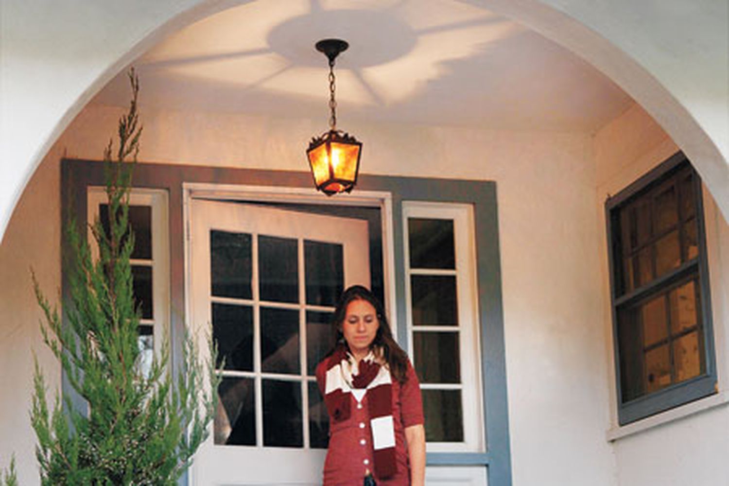 a vintage entry lantern hanging on a porch
