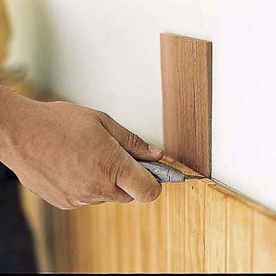 cutting the wainscoting to fit the wall