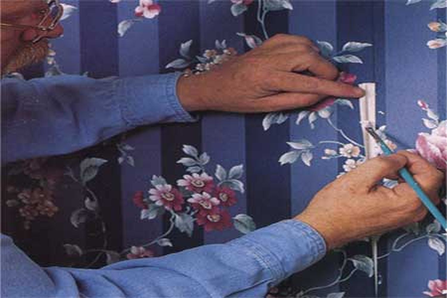 Someone repairing damaged wallpaper