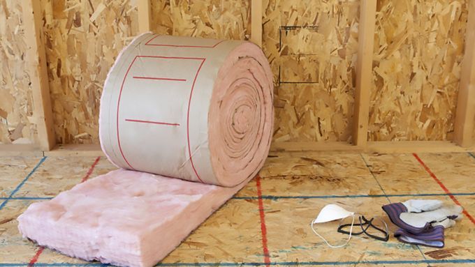 A roll of insulation sitting in the walls of a home.