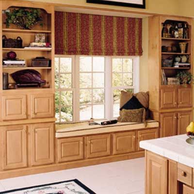 Cabinets around a window with a built-in bench.