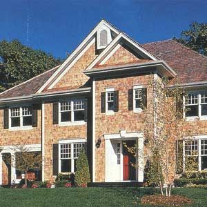 An image of divided-light, double-hung windows that are made of a composite-plastic material that won't warp or rot and can be painted.