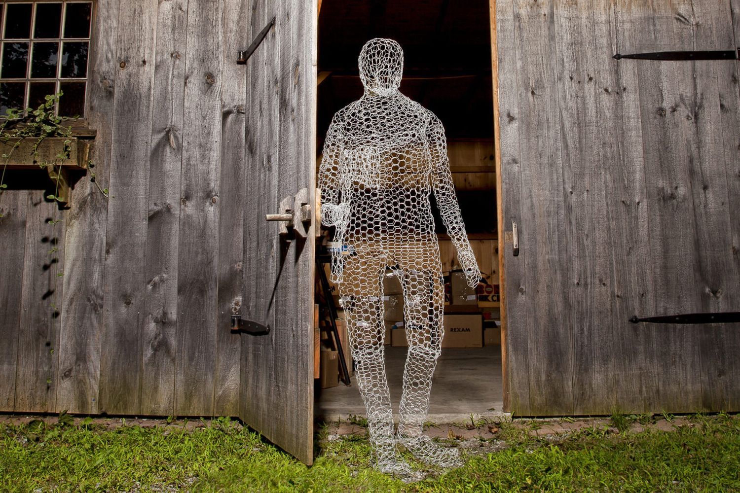 The silhouette of a man made out of chicken wire.