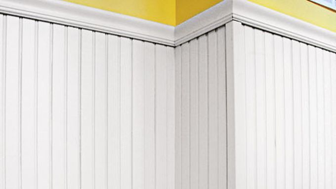 White painted wood beadboards being used as wainscoting.