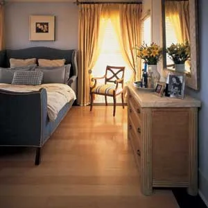 Engineered flooring looks like solid wood, but it's made from thin, cross-laminated wood plies that are glued together to form strips or planks. A factory-applied finish like the one on this Maple Harborlight flooring from Bruce Hardwood Floors is very durable, so you can walk on this floor as soon as it's installed.