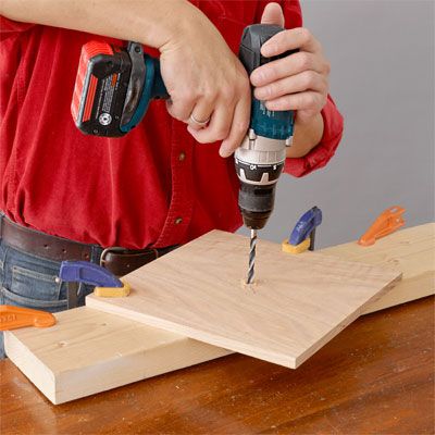 A drill being used to  build a tiered serving tray.